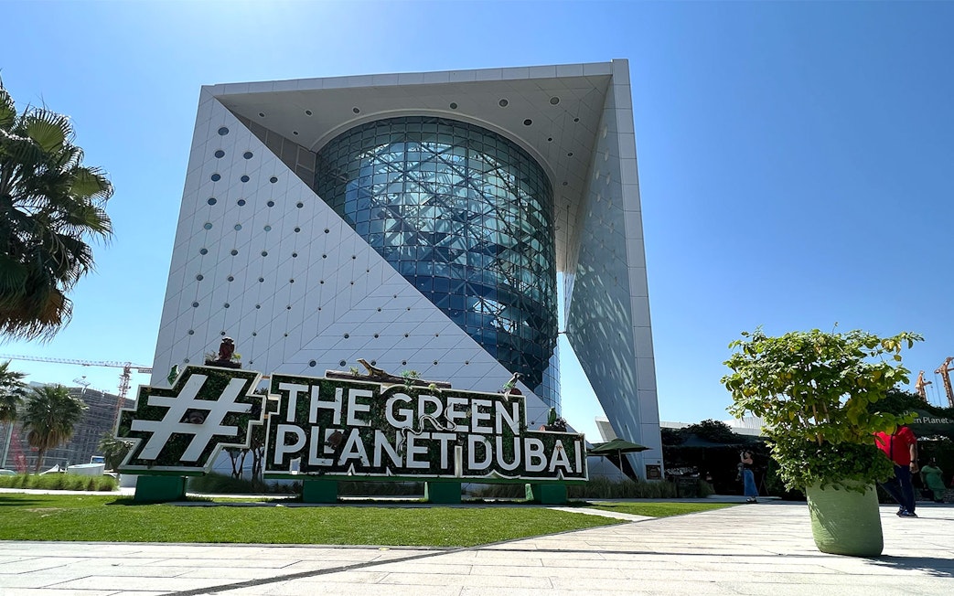 Green Planet Dubai exterior with lush greenery and unique architecture.