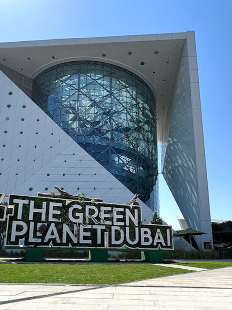 Green Planet Dubai exterior with lush greenery and unique architecture.