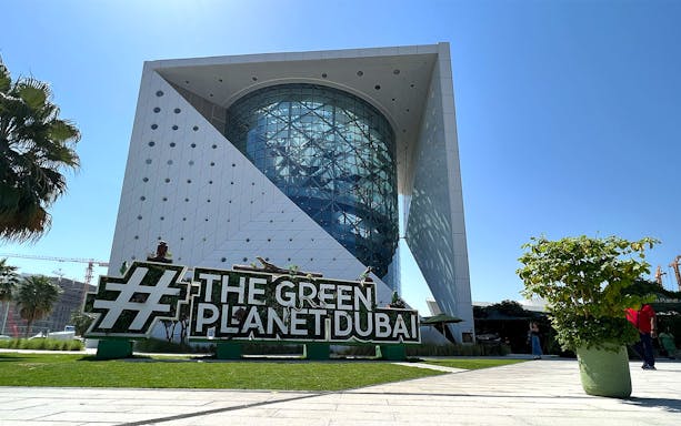 Green Planet Dubai exterior with lush greenery and unique architecture.