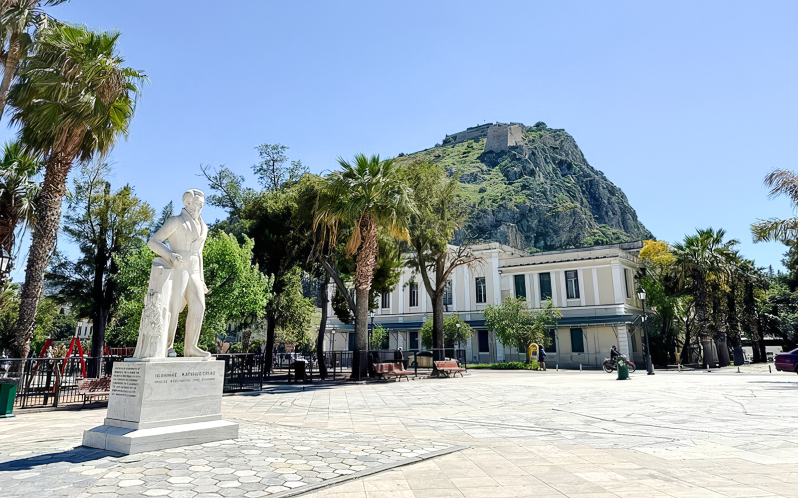 Statue of Ioannis Kapodistrias in Kapodistrias Square, Nafplio, Greece, with Palamidi Fortress in background.