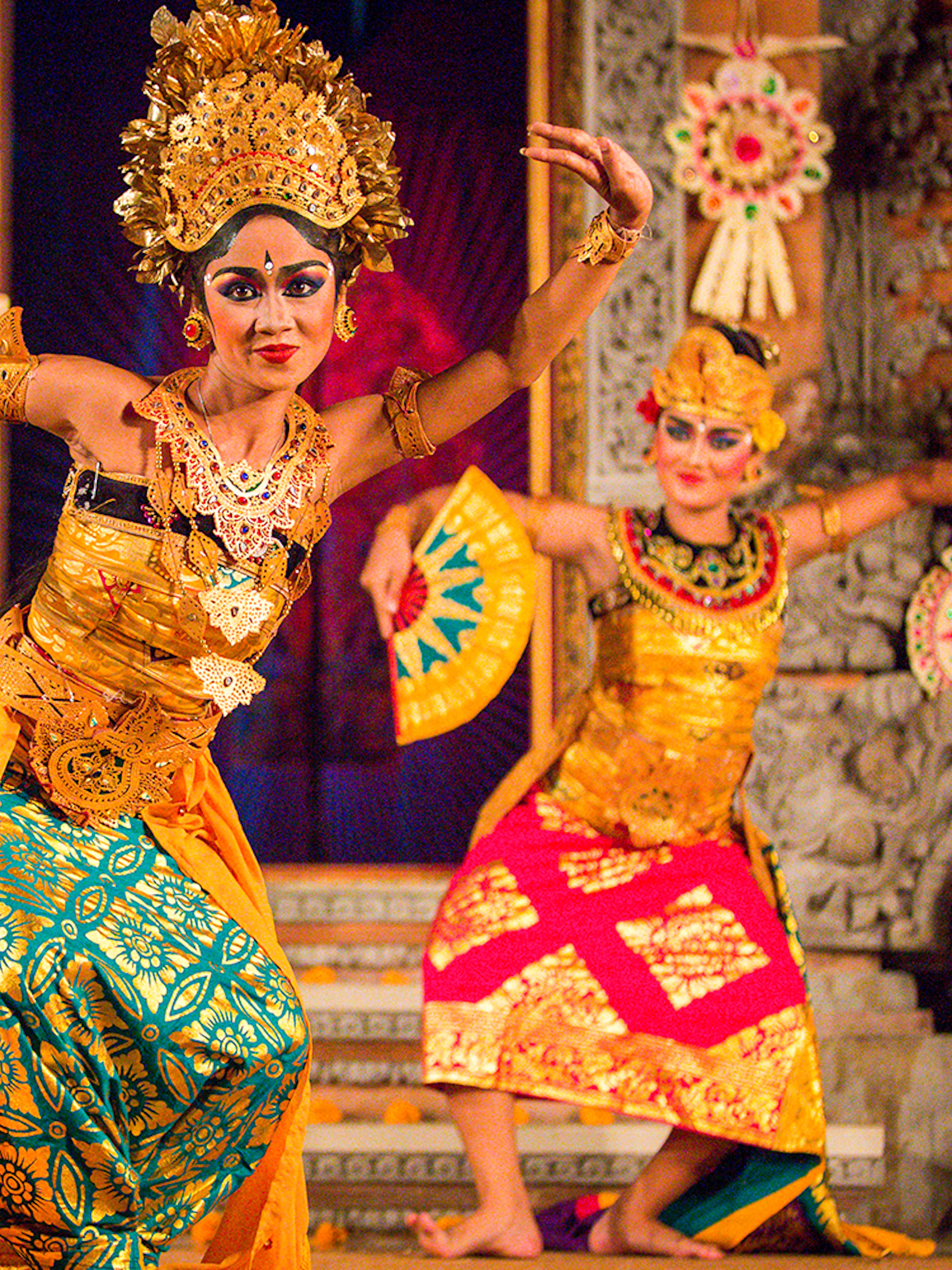Legong dancers performing at Ubud Palace, Bali, in traditional costumes.