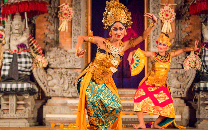Legong dancers performing at Ubud Palace, Bali, in traditional costumes.