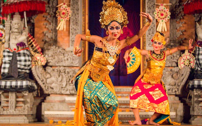 Legong dancers performing at Ubud Palace, Bali, in traditional costumes.
