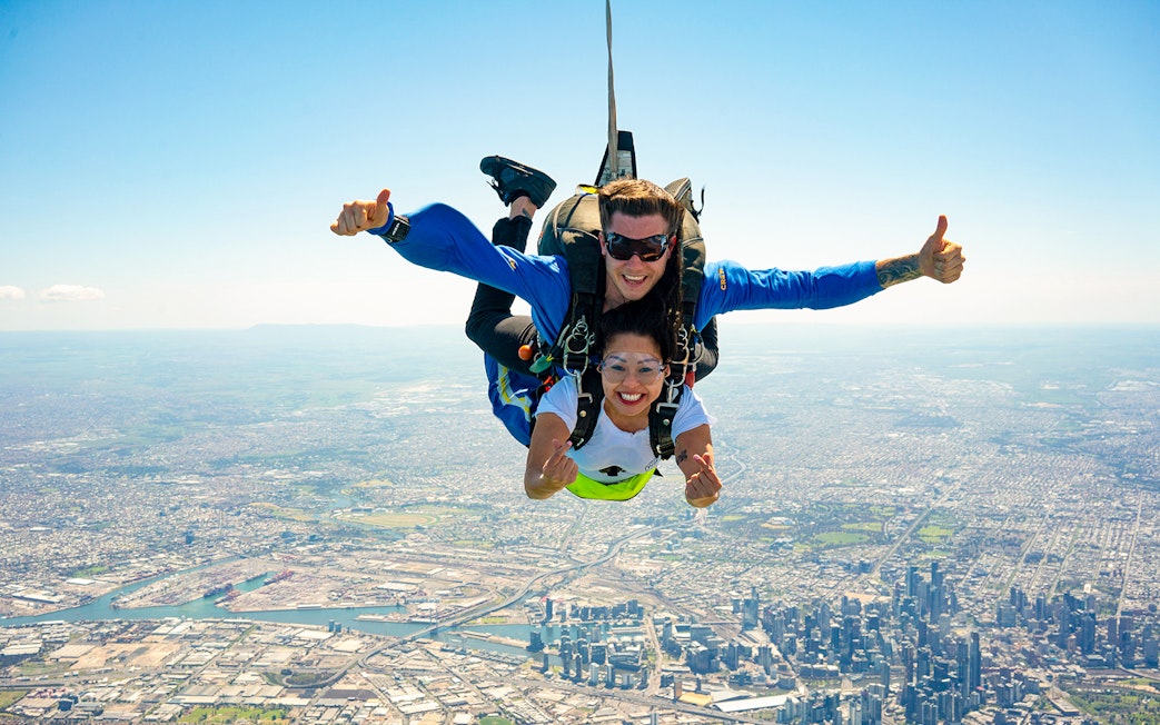 Tandem skydive over Melbourne with view of St Kilda Beach and cityscape below.