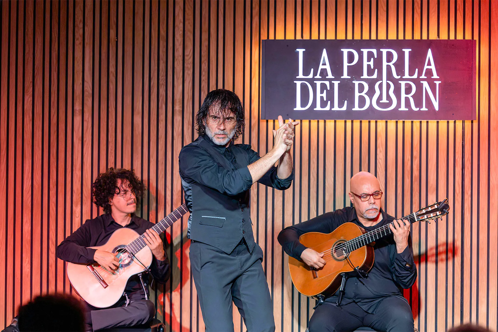 Flamenco performance at La Perla del Born in Barcelona with two guitarists and a dancer.