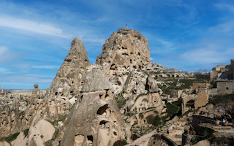 Rock formations and cave dwellings near Kaymakli Underground City, Cappadocia, Turkey.
