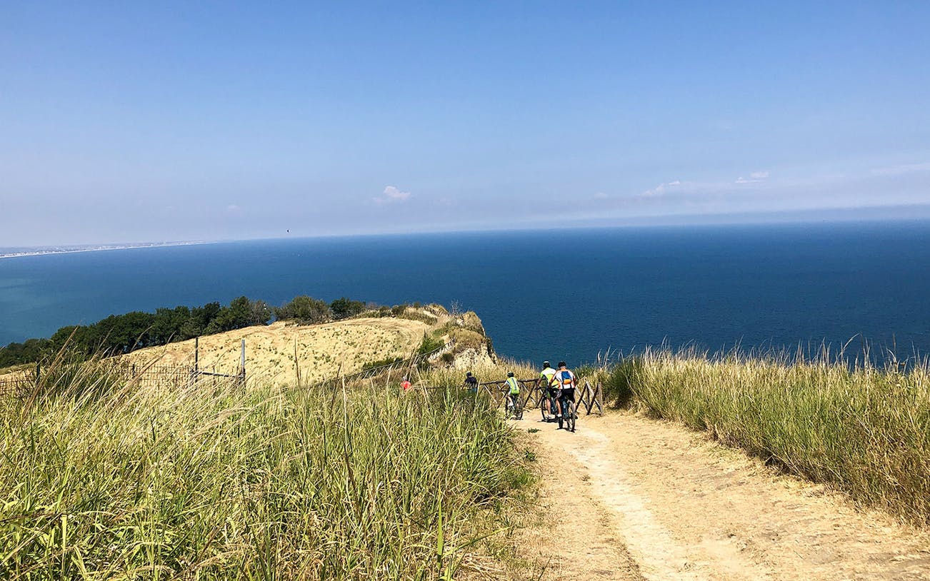 E-bikers on a trail overlooking the sea on San Bartolo Mount.