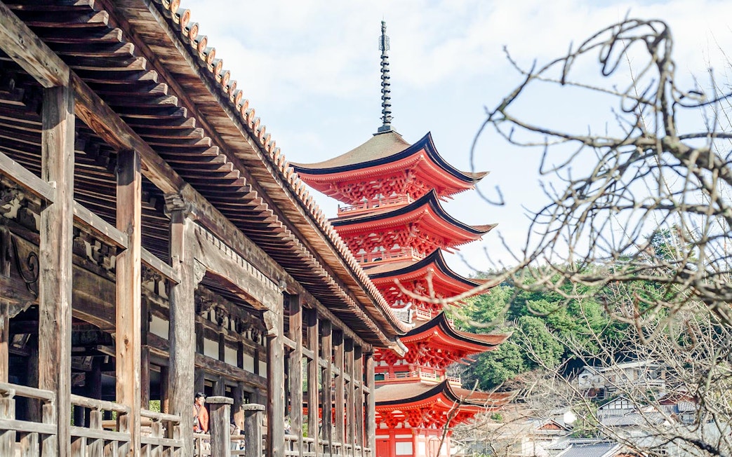 Pagoda at Itsukushima Shrine on Miyajima Island, Japan, with wooden temple structure.
