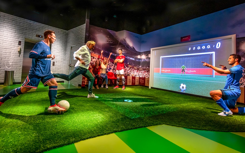 Penalty kick experience at Madame Tussauds Dubai with interactive soccer display.