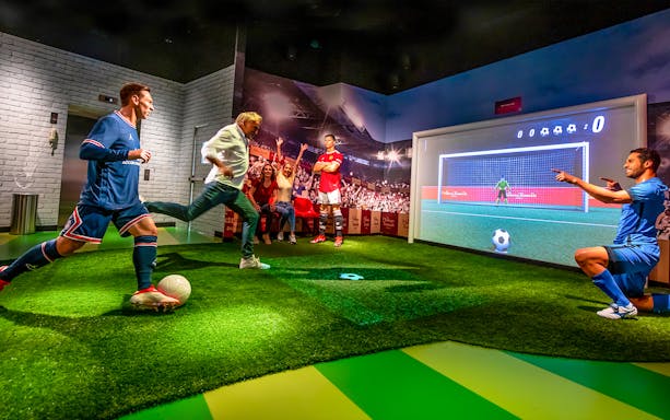 Penalty kick experience at Madame Tussauds Dubai with interactive soccer display.