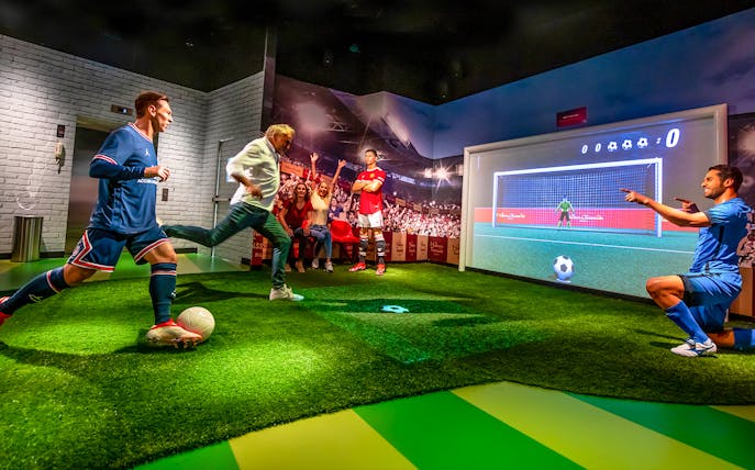 Penalty kick experience at Madame Tussauds Dubai with interactive soccer display.