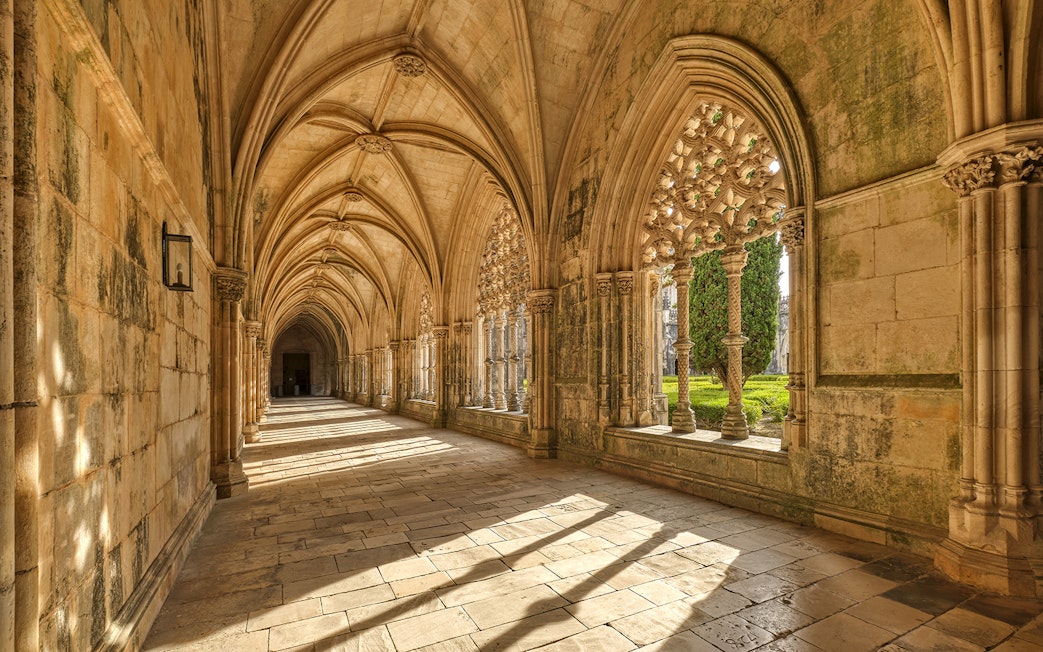 Cloister arches and stone columns at Batalha Monastery, Portugal.