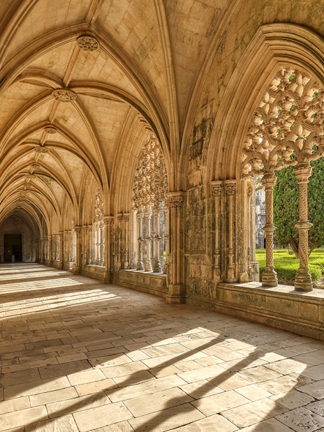 Cloister arches and stone columns at Batalha Monastery, Portugal.
