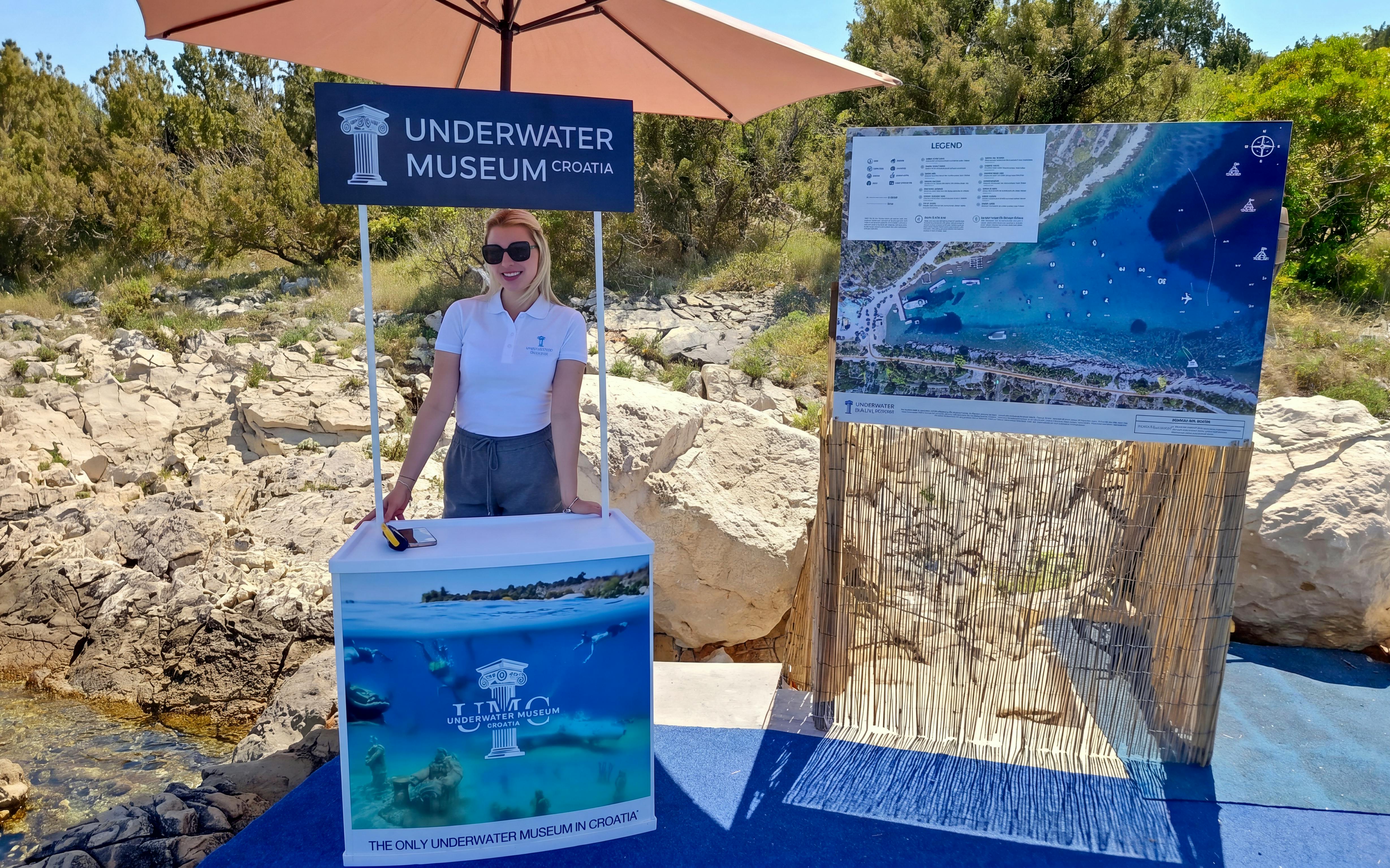 Underwater Museum Croatia information booth with map display at beach resort.