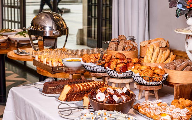 Breakfast buffet with pastries, bread, cakes, and cereals at Flora Danica.