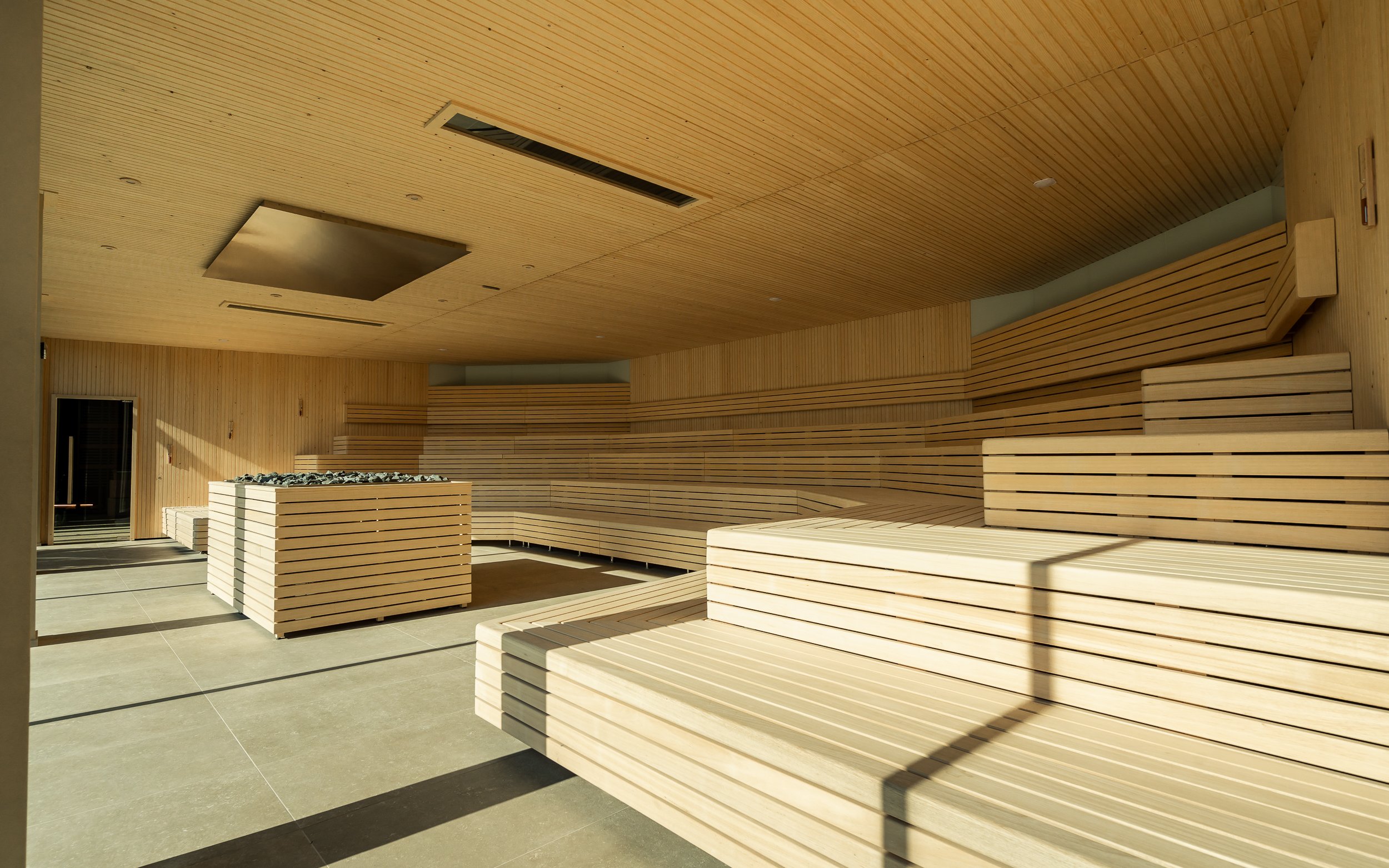 Spacious sauna room with wooden benches at Milan Wellness Spa.