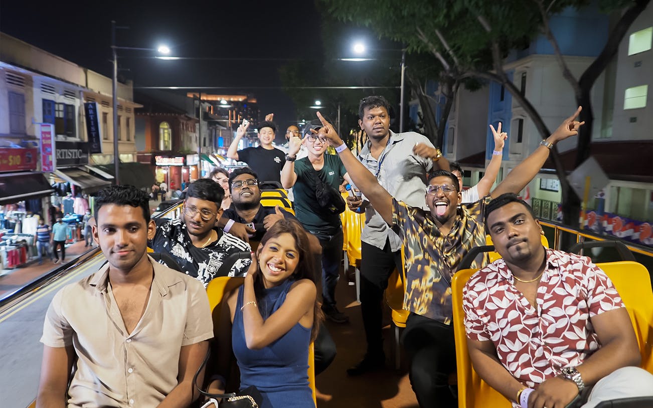 Group enjoying Singapore FunVee Party Bus Pub Crawl at night.