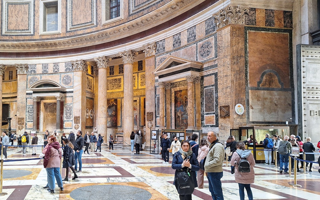 Visitors exploring the interior of the Pantheon in Rome, Italy.