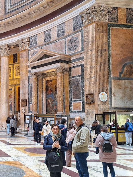 Visitors exploring the interior of the Pantheon in Rome, Italy.