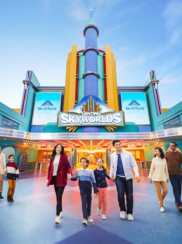 Families walking in front of Genting SkyWorlds Theme Park entrance.