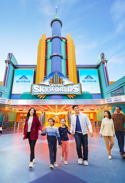 Families walking in front of Genting SkyWorlds Theme Park entrance.