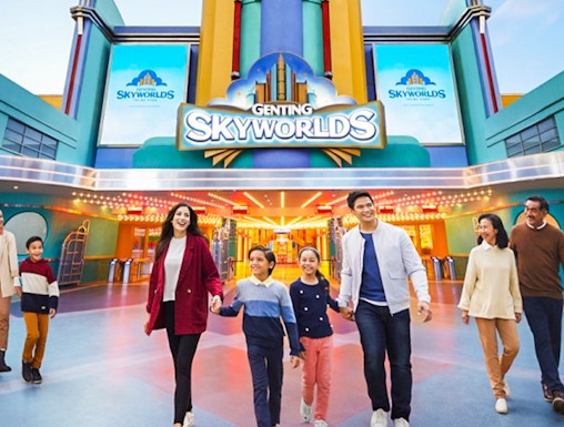 Families walking in front of Genting SkyWorlds Theme Park entrance.