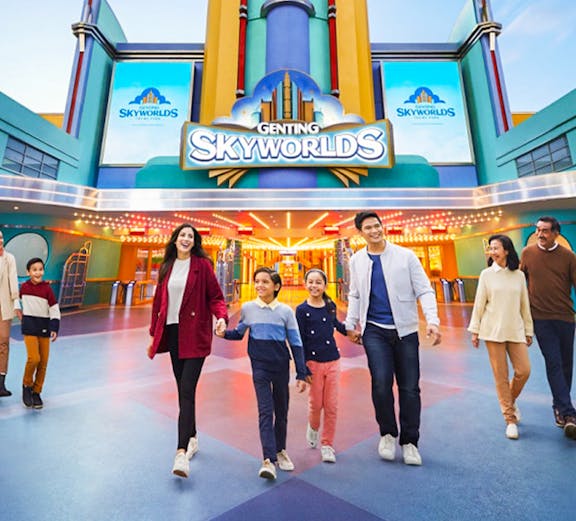 Families walking in front of Genting SkyWorlds Theme Park entrance.