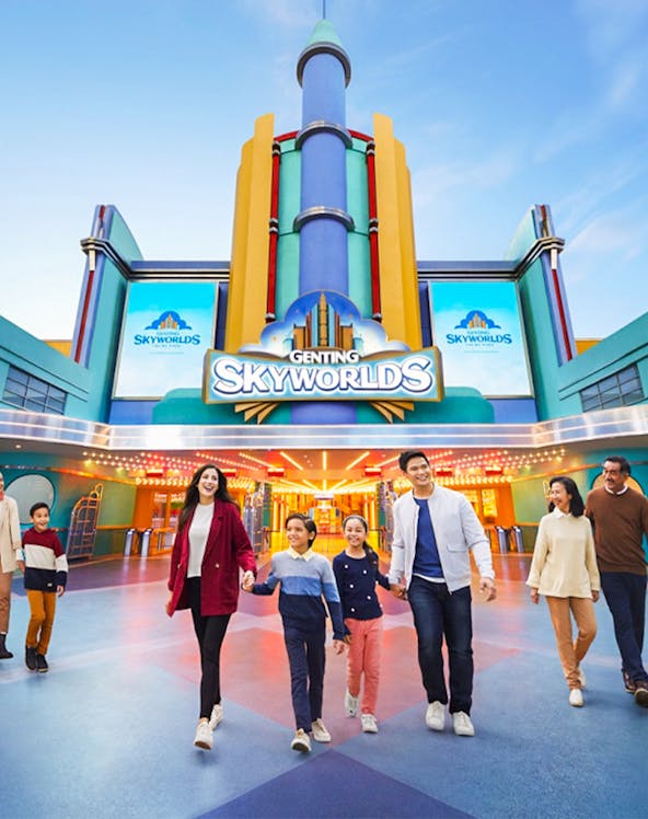 Families walking in front of Genting SkyWorlds Theme Park entrance.