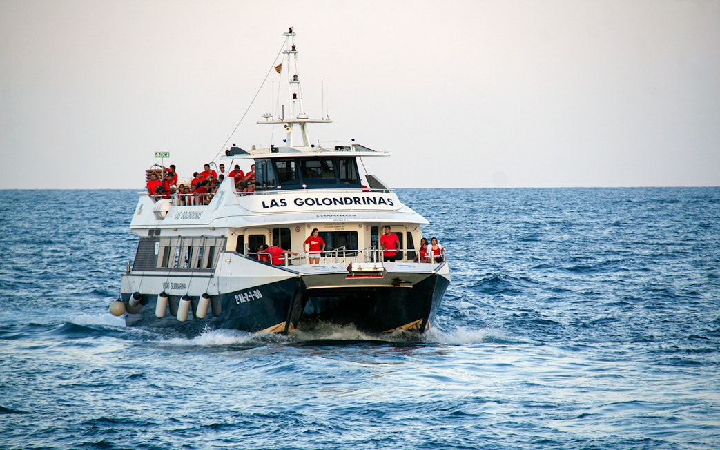 Las Golondrinas boat with passengers on a sea trip.
