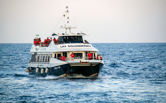 Las Golondrinas boat with passengers on a sea trip.