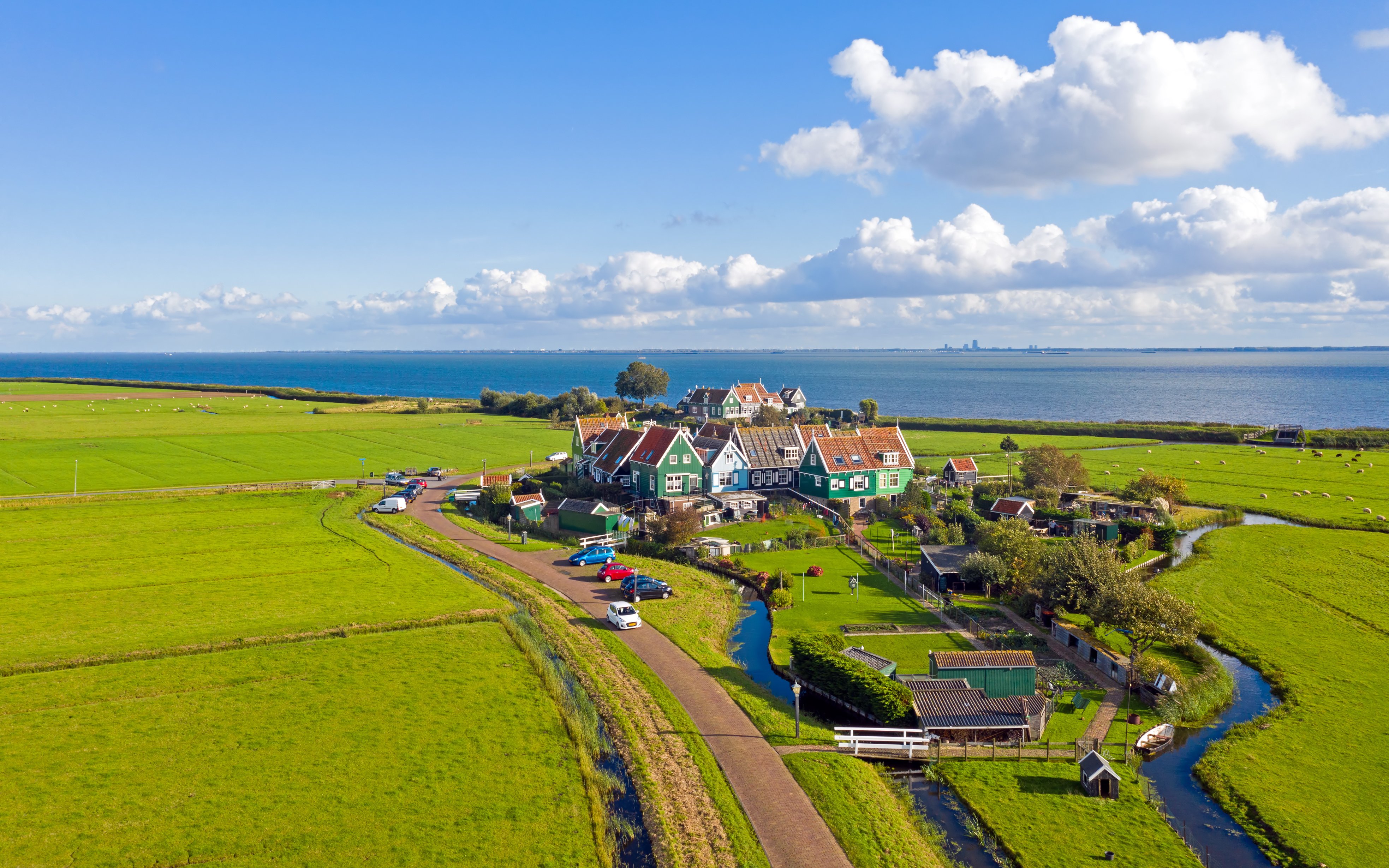 Aerial view of Marken village with green fields and IJsselmeer in the Netherlands.