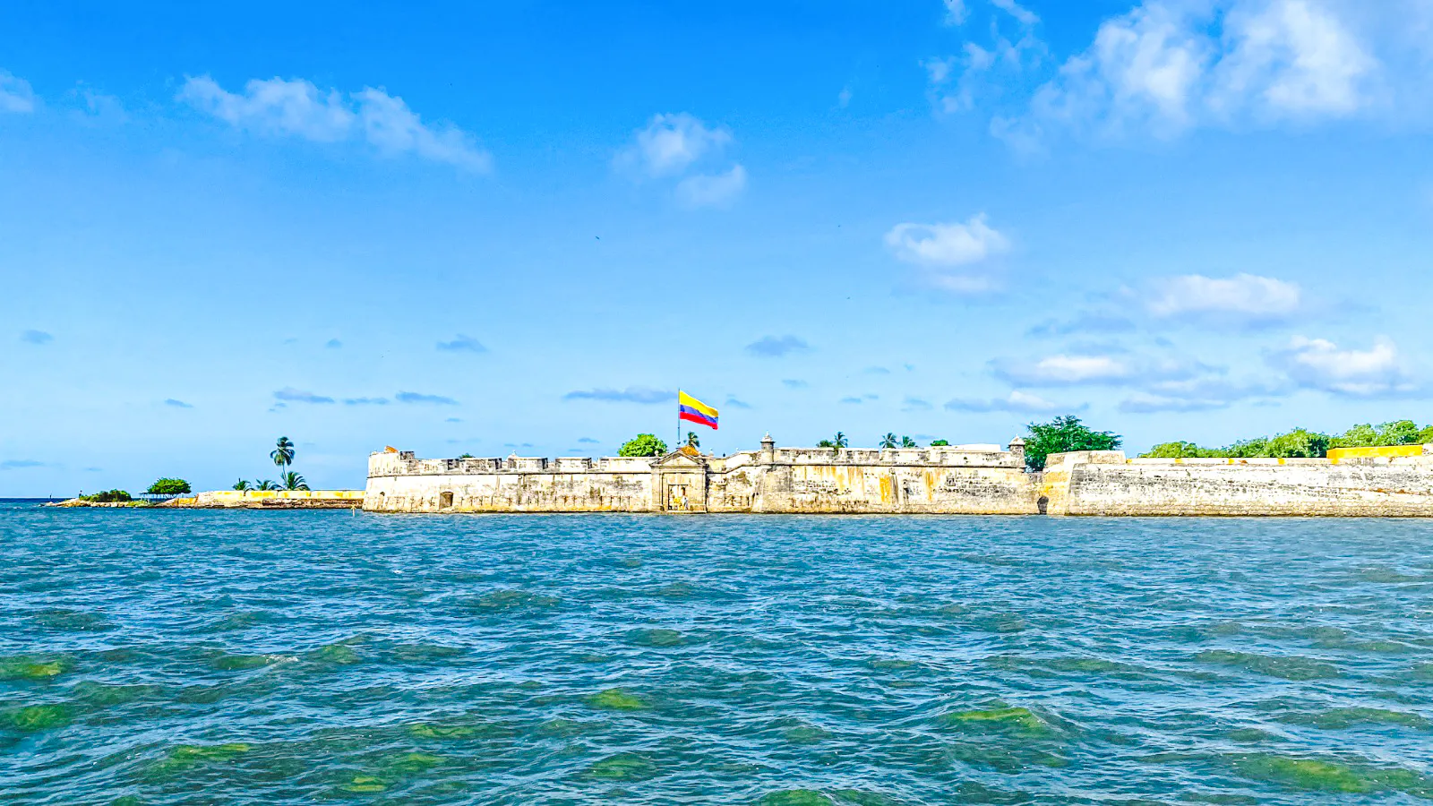 Historic fort with Colombian flag on Rosario Islands beach, Cartagena.