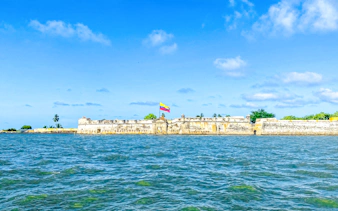 Historic fort with Colombian flag on Rosario Islands beach, Cartagena.