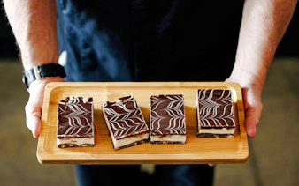 Chocolate desserts on a wooden tray during Seattle Center food tour.