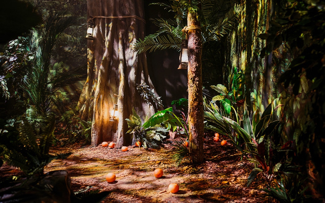 Peru-themed jungle setup with lanterns and oranges at Paddington Bear Experience, London.