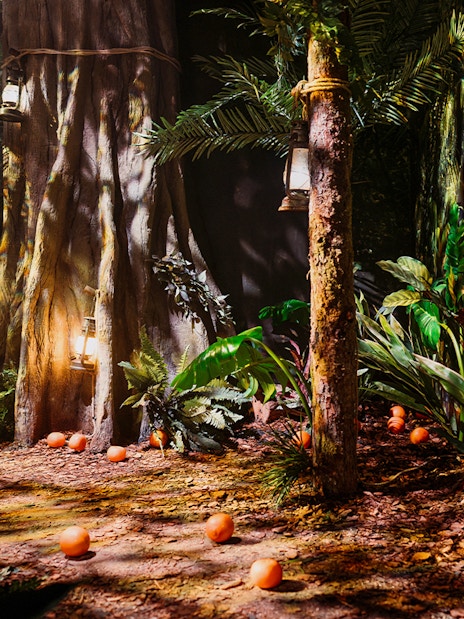 Peru-themed jungle setup with lanterns and oranges at Paddington Bear Experience, London.