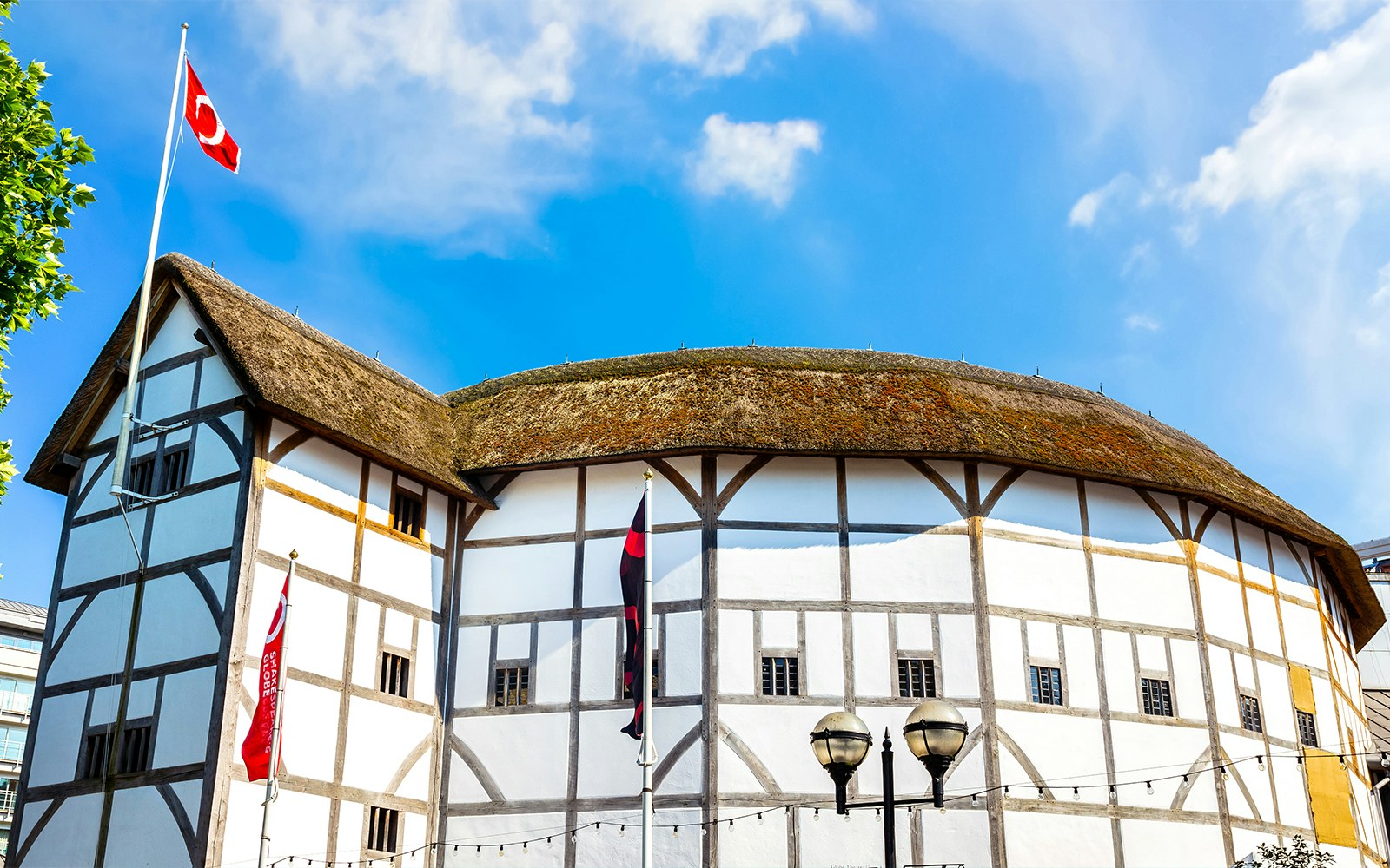 Shakespeare's Globe Theatre with thatched roof in London, UK.