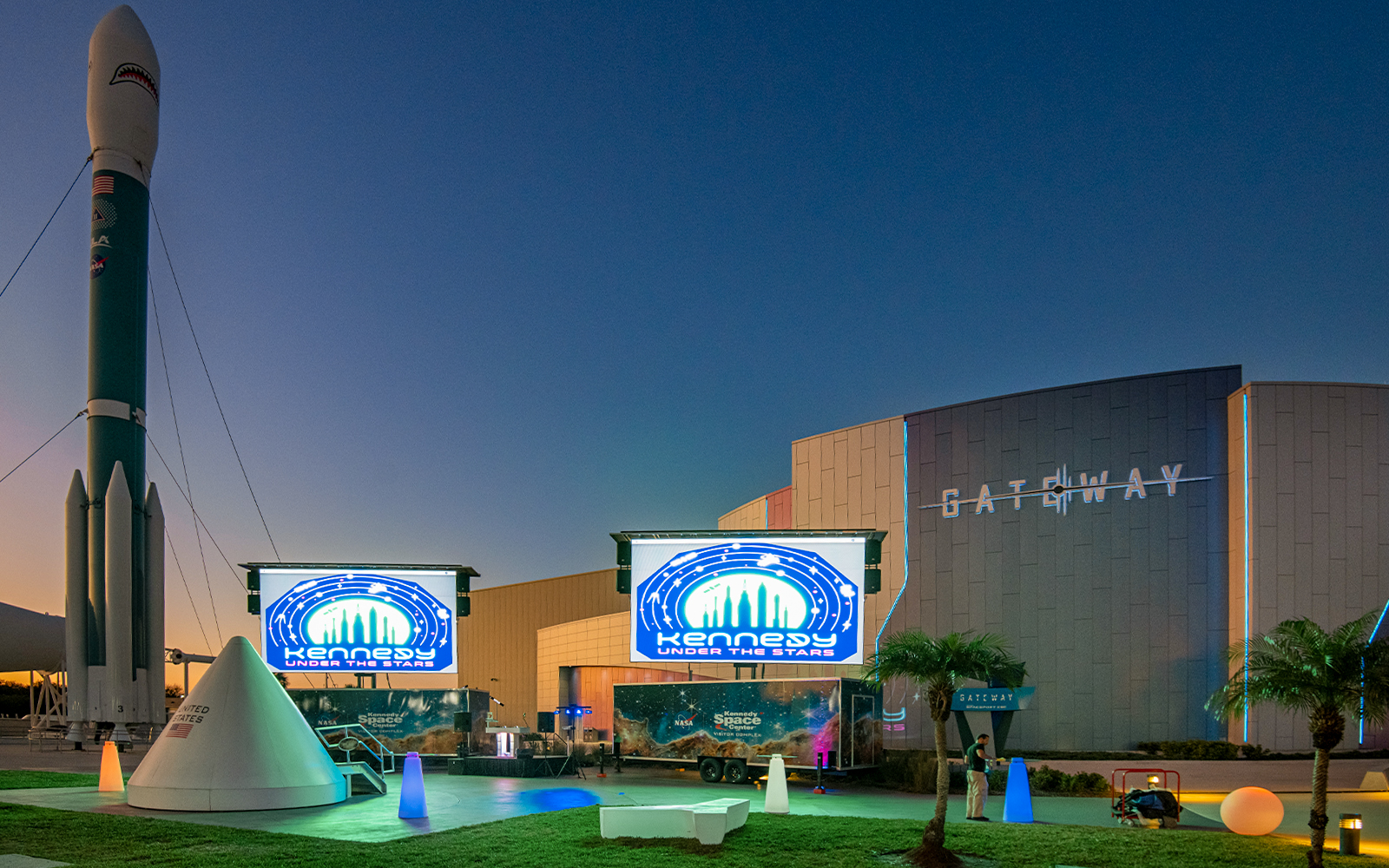 Kennedy Space Center Under The Stars venue with illuminated rocket display.