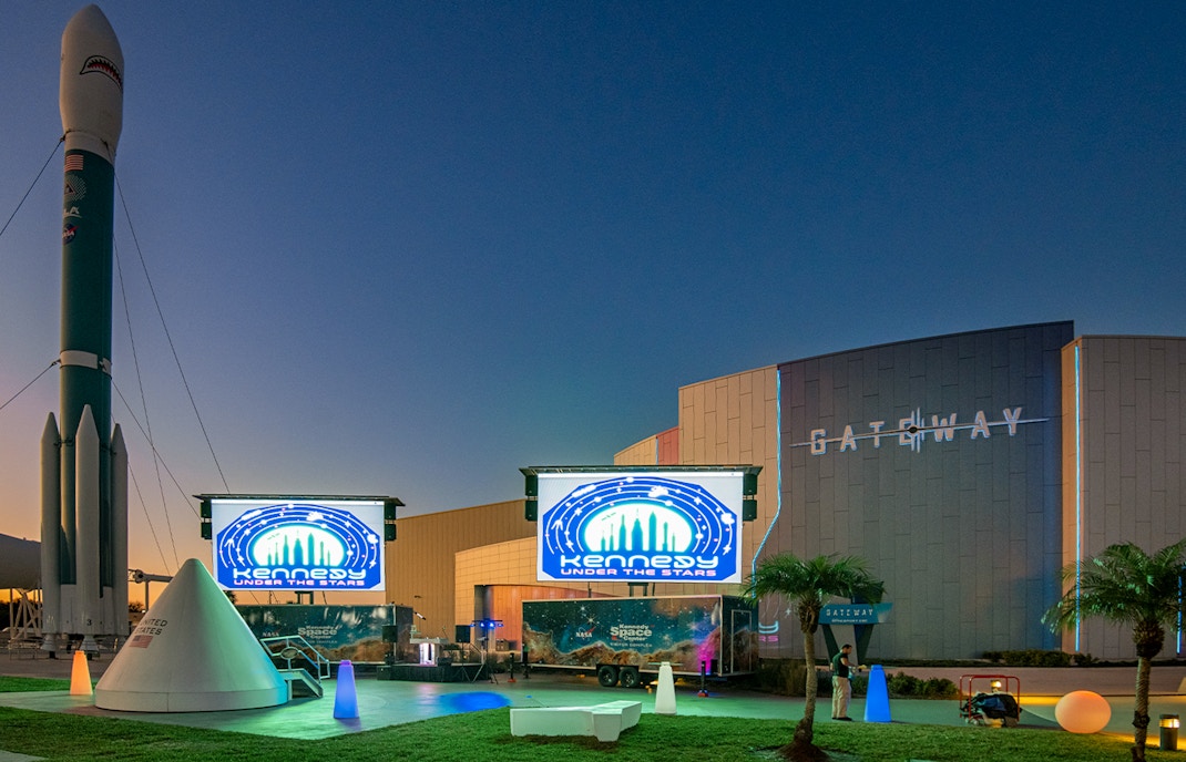 Kennedy Space Center Under The Stars venue with illuminated rocket display.