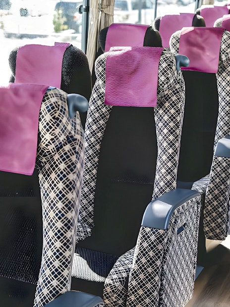 Interior seating of airport transfer bus from Kansai Airport.