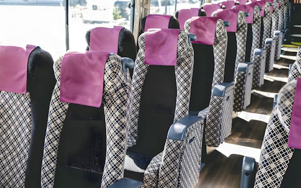 Interior seating of airport transfer bus from Kansai Airport.