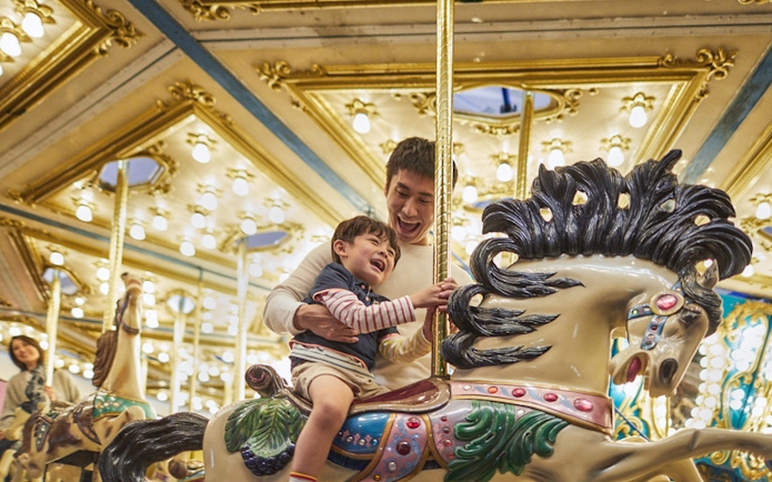 Father and child enjoying a carousel ride at Ocean Park.
