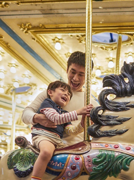 Father and child enjoying a carousel ride at Ocean Park.