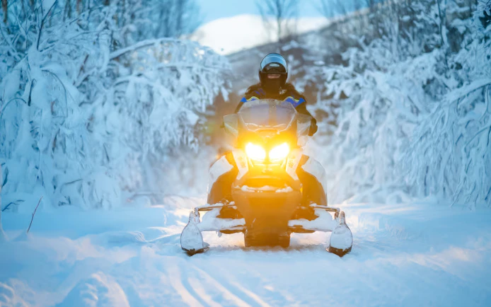 Snowmobile on snowy trail during small-group day trip in Tromso.