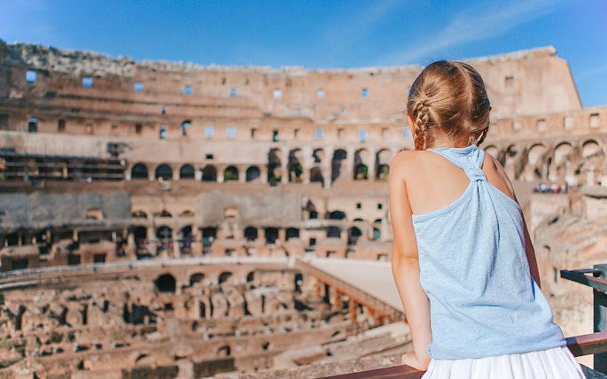 Child observing the interior of the Colosseum in Rome during a family-friendly Gladiator Tour.