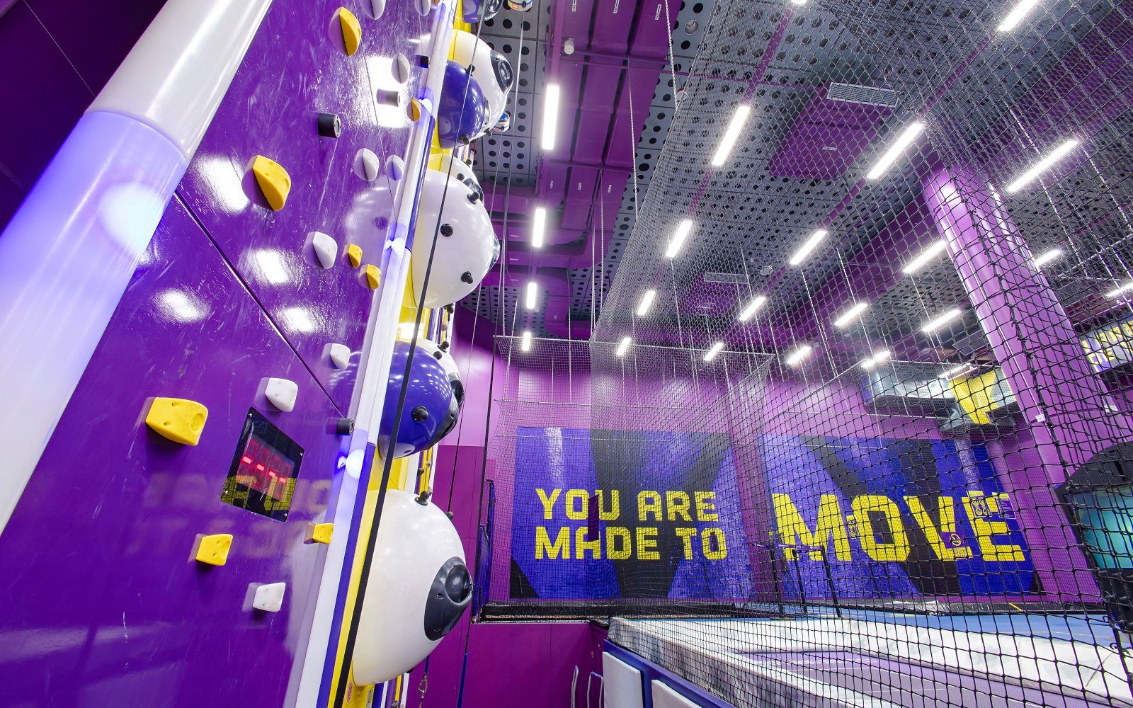 Indoor climbing wall and trampoline area at SuperPark Singapore.