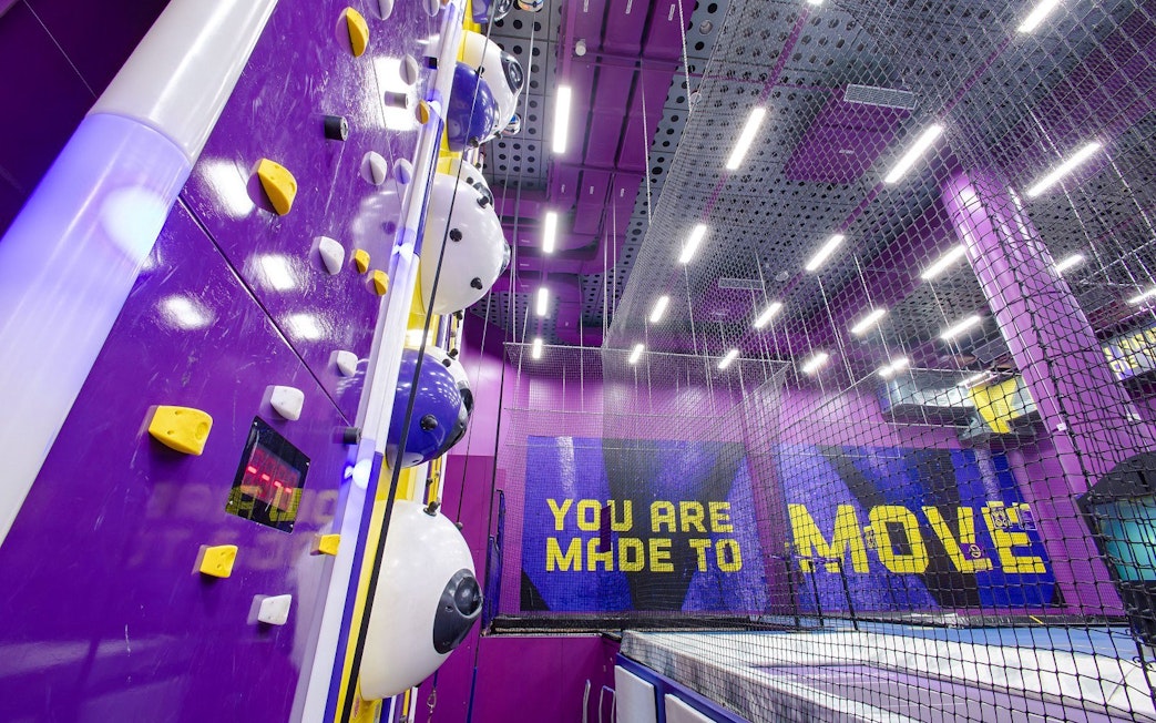 Indoor climbing wall and trampoline area at SuperPark Singapore.