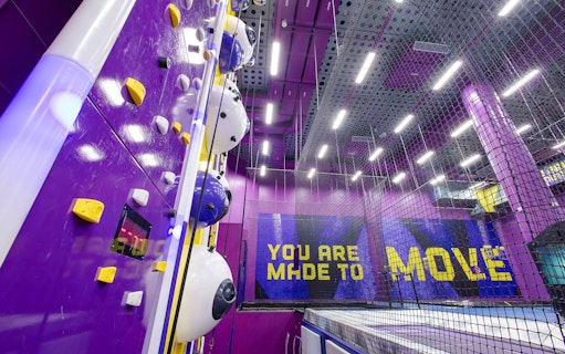 Indoor climbing wall and trampoline area at SuperPark Singapore.