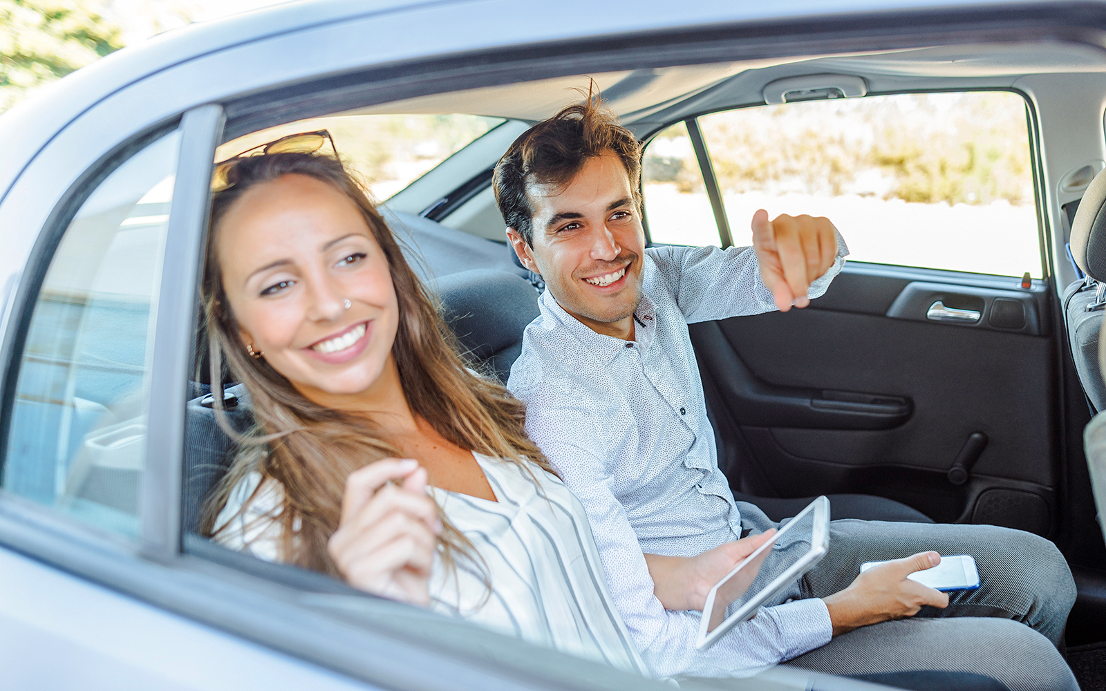 Couple sitting in the back seat of a car