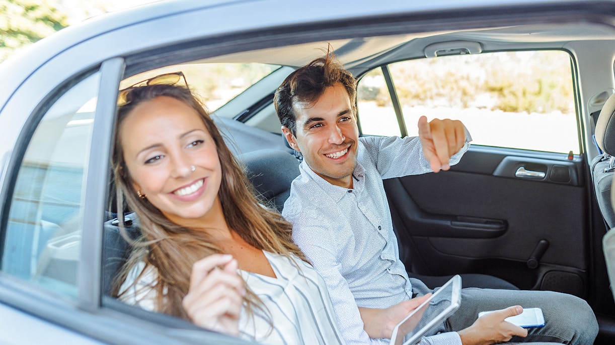Couple sitting in the back seat of the car